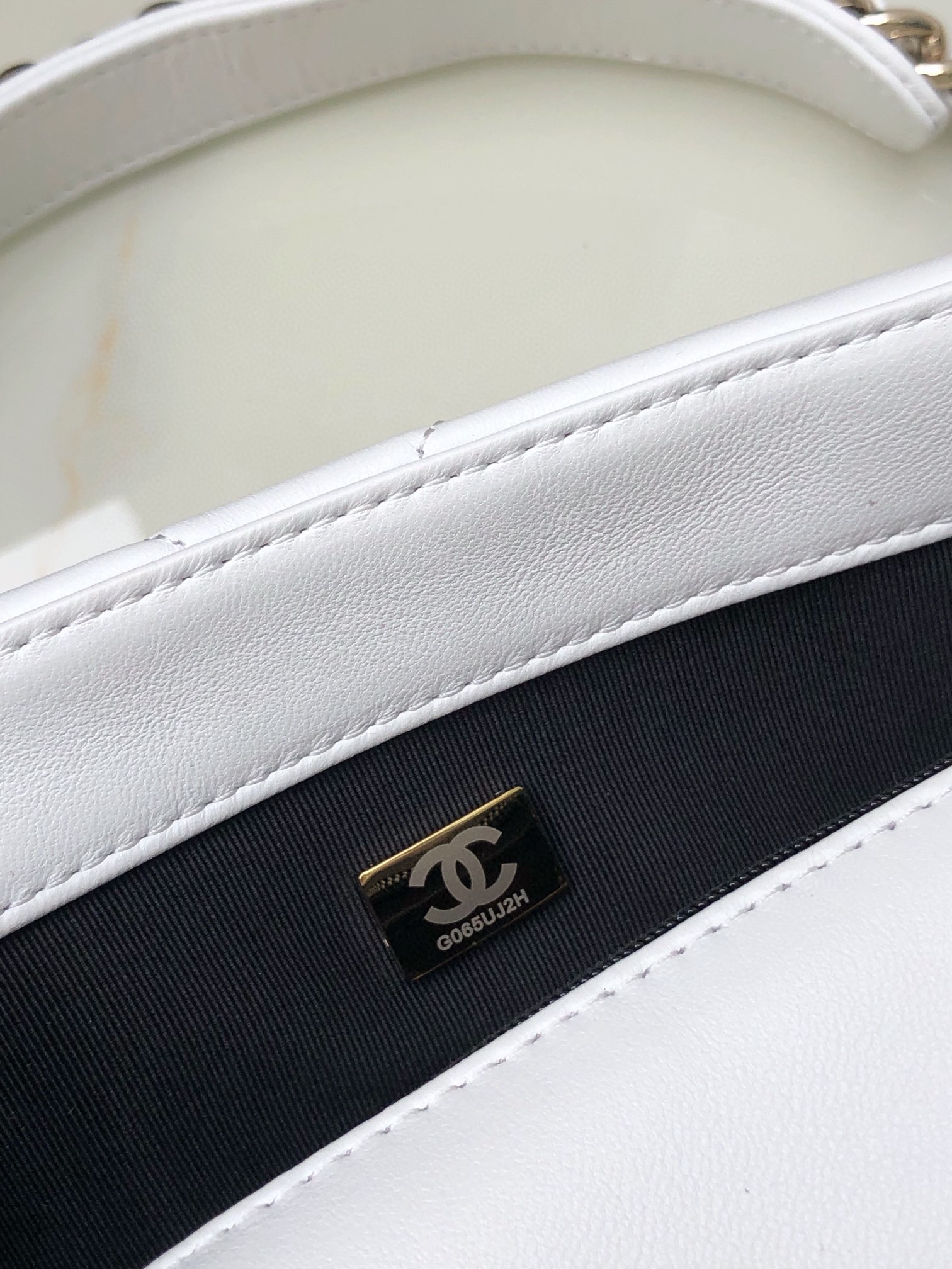 Ch*el 19 handbag shiny leather, gold-tone, silver-tone & ruthenium-finish metal white 6.2 × 10.1 × 3.5 in